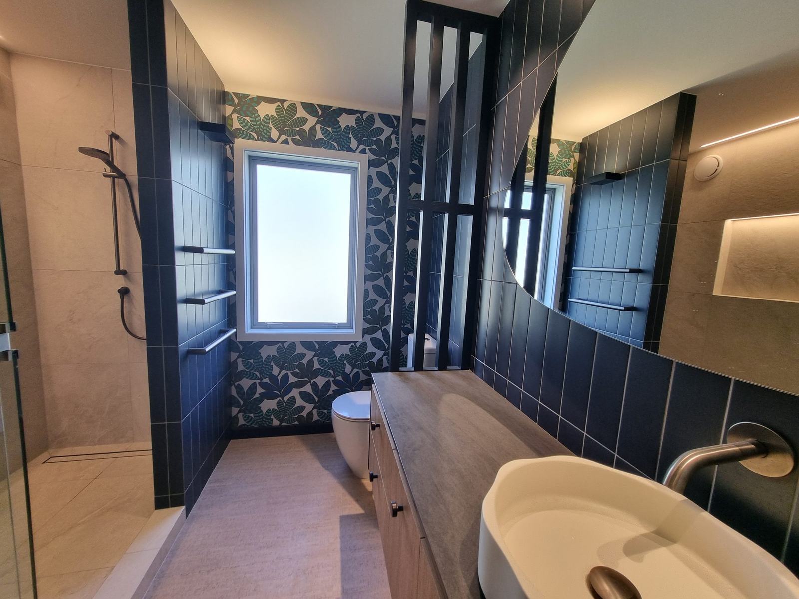 Navy tile and wallpaper bathroom with recessed niche