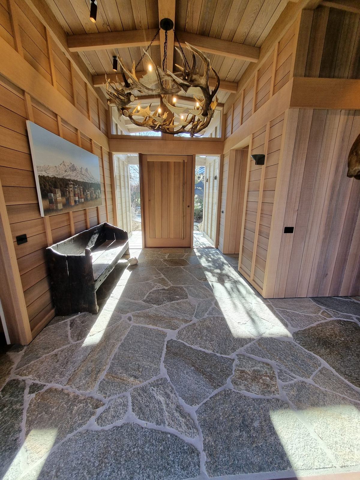 Natural stone crazy paving through a timber-lined entry hall, Taupō