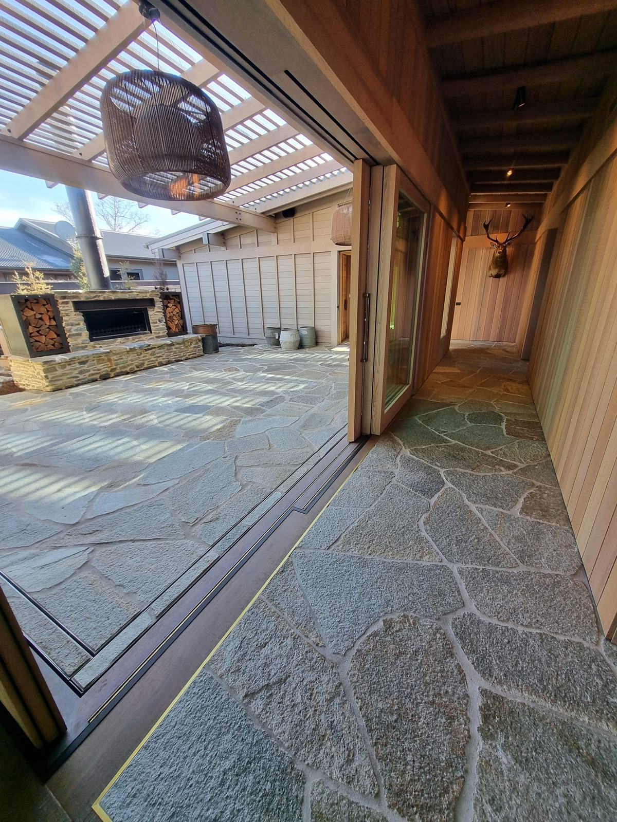 Natural stone crazy paving through a timber-lined terrace, Kinloch