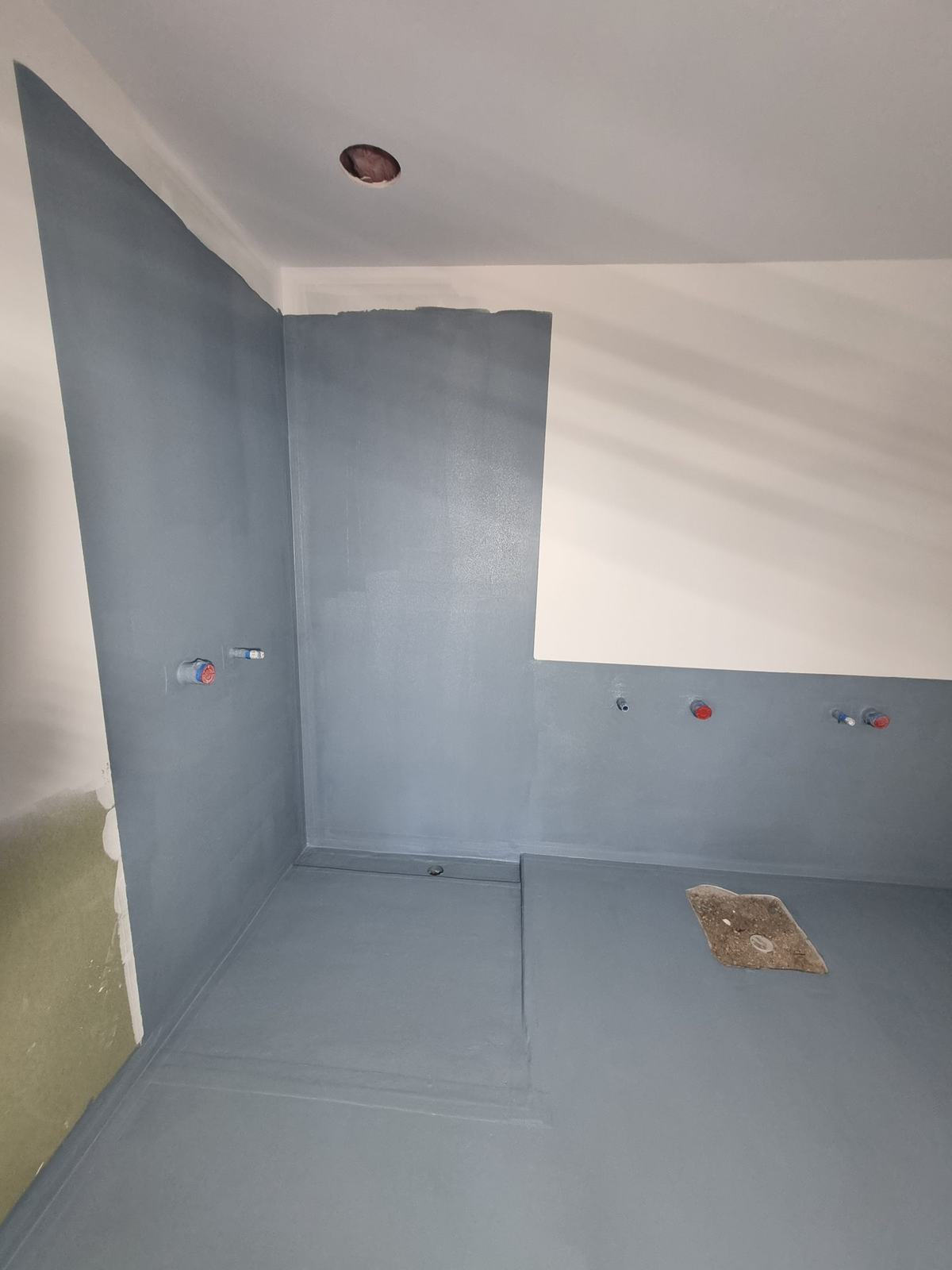 Waterproofing membrane applied to a shower and bathroom floor before tiling